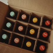 Selection of 12 Momo Kombucha bottles in packaging - ready to go to a customer.